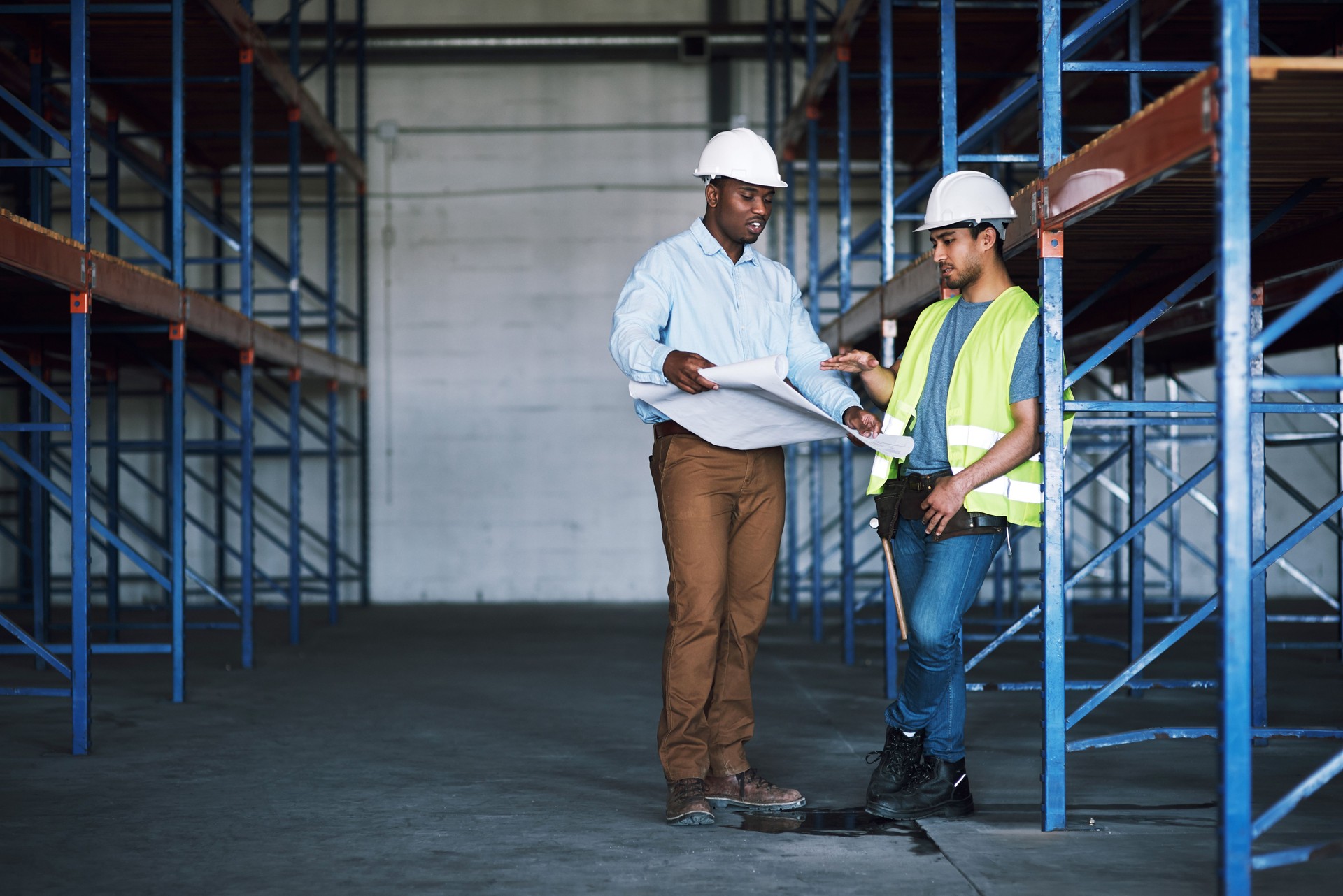 Shot of two builders having a meeting at a construction site